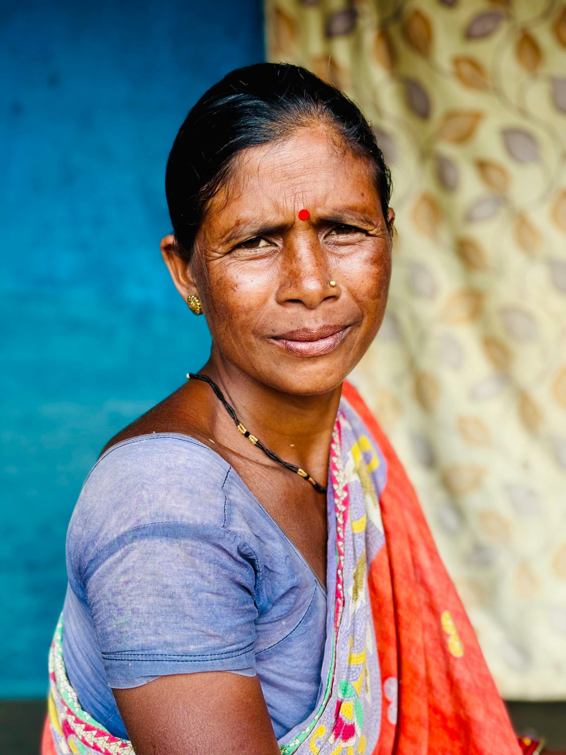 Home Close-up portrait of a South Asian woman wearing traditional attire, showcasing cultural heritage.
